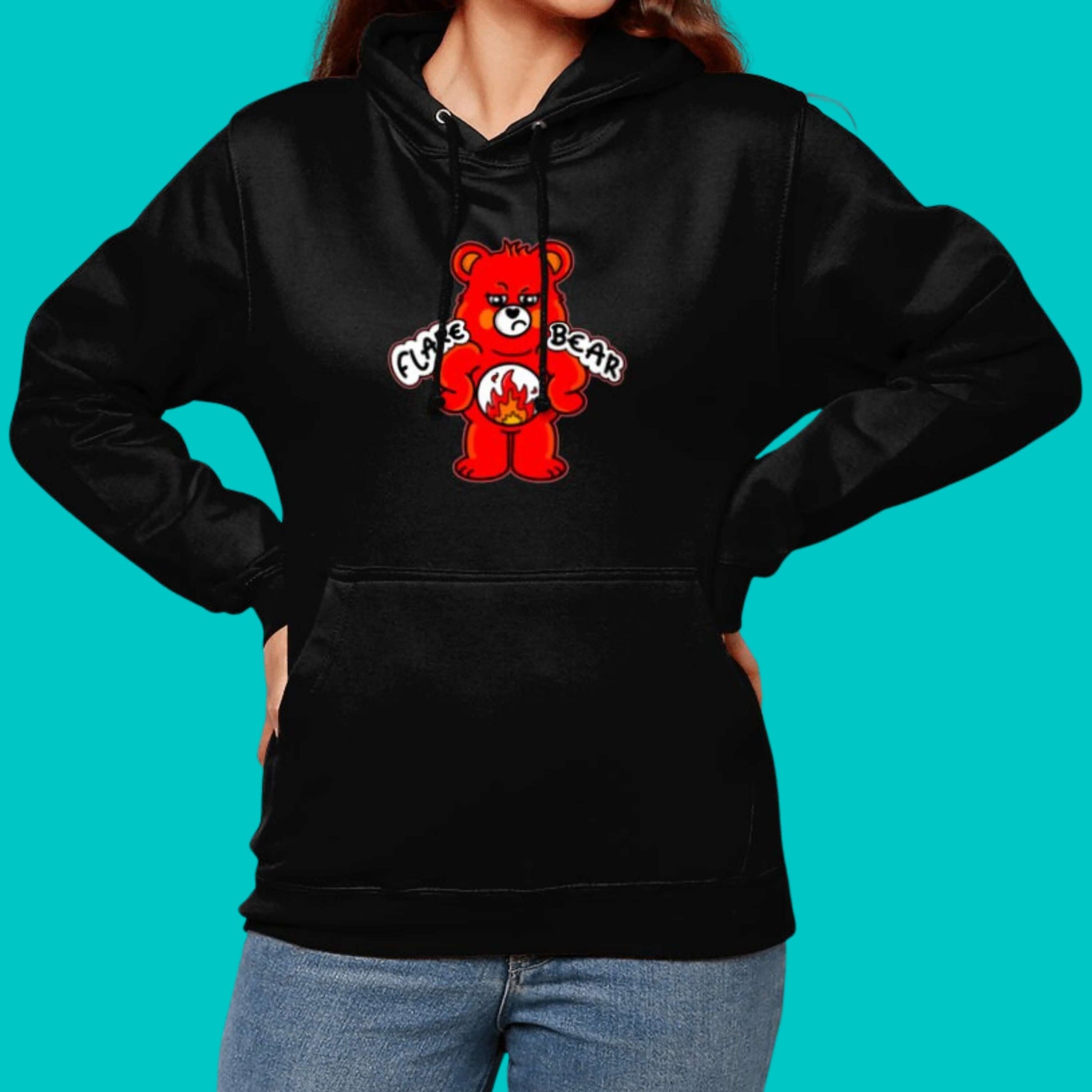 Flare Bear black hoodie jumper modelled on a blue background. The hoodie is of a red bear with a fed up expression and hands on its hips. There is a white circle on its belly with flames inside. Flare Bear is written on the hoodie. The hoodie is designed to raise awareness for chronic illness flare ups.
