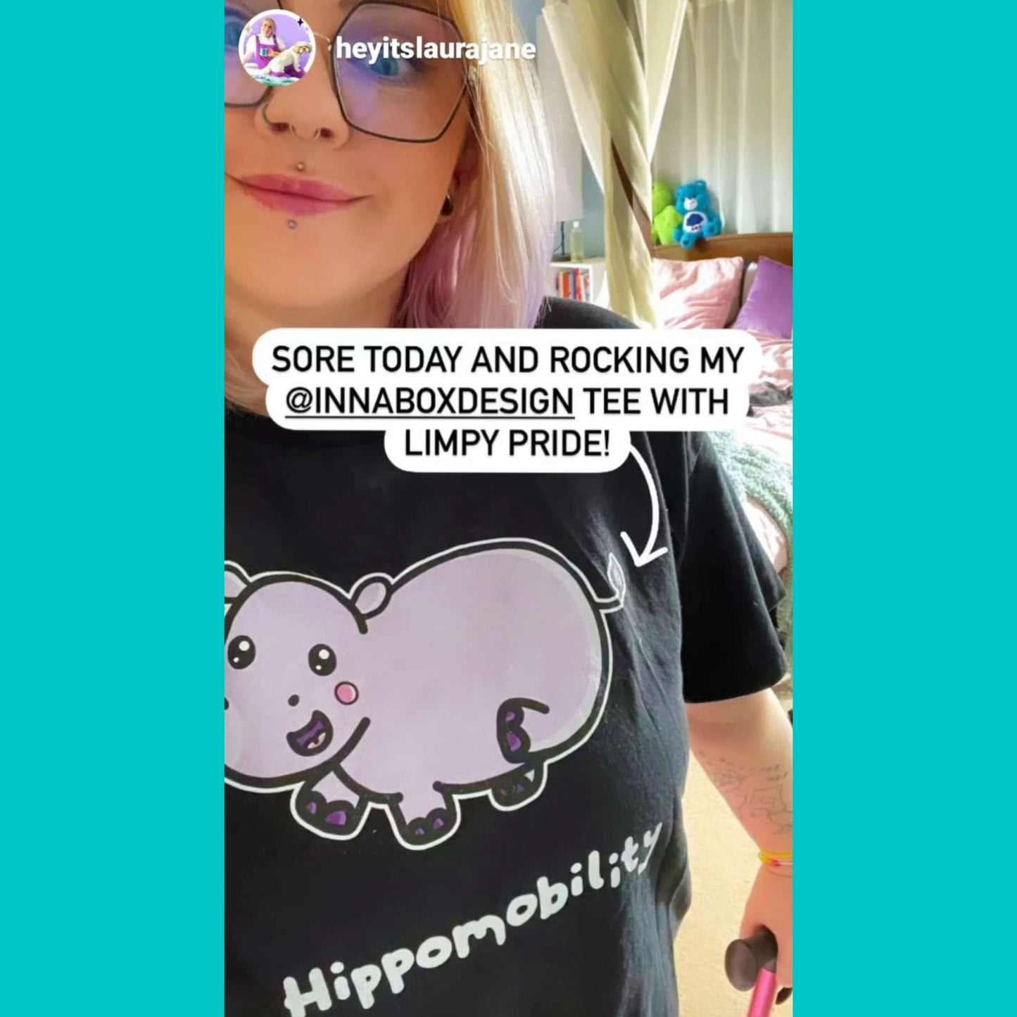 Femme person wearing Hippomobility Tee - Hyper Mobility Tee screenshot taken from instagram user @heyitslaurajane. The black t-shirt has an illustration of a pink happy hippo with 'hippomobility' in white text underneath. The hand drawn design is made to raise awareness for hyper mobility.
