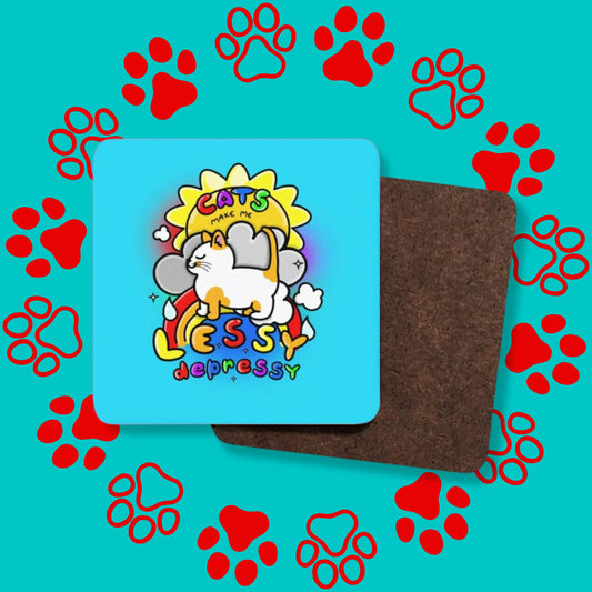A collage of the Cats Make Me Lessy Depressy Coaster facing forward and backwards to show the plain wooden back on a red and blue paw print background. The blue wooden rounded edges coaster has a smiling orange and white cat with a sunshine, raincloud and rainbow, in rainbow text across this reads 'cats make me lessy depressy'. Hand drawn design to raise awareness for mental health and depression.