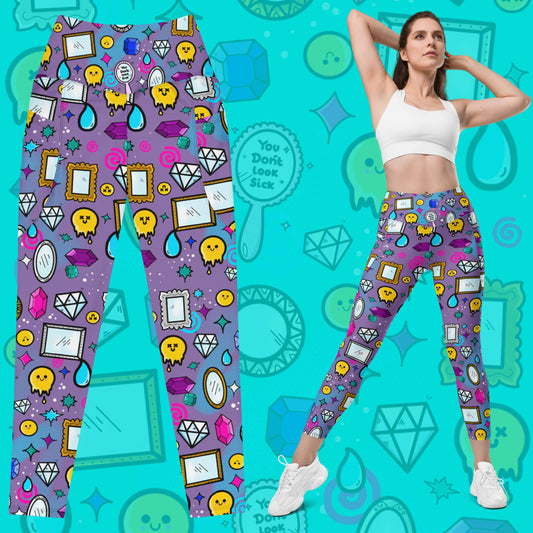 The You Don't Look Sick Leggings with pockets on a blue background with a faded version of the print, on the right is a femme model posing in them with white trainers and white crop top. The purple base leggings features melting yellow smiley faces, mirrors, gemstones, teardrops, sparkles, swirls and dots with a centre hand held mirror reading 'you don't look sick'. The hand drawn design is raising awareness for invisible illnesses.