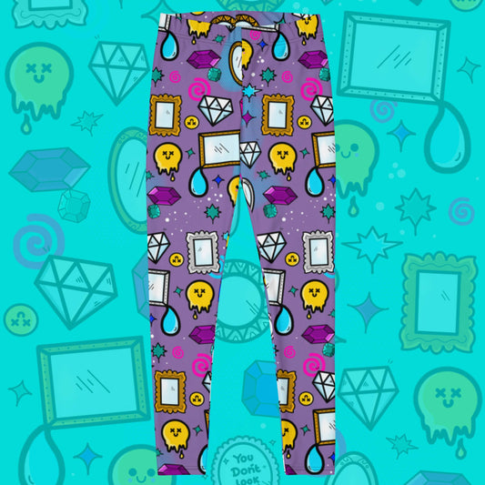 The You Don't Look Sick Leggings on a blue background with a faded version of the print. The purple base leggings features melting yellow smiley faces, mirrors, gemstones, teardrops, sparkles, swirls and dots with a centre hand held mirror reading 'you don't look sick'. The hand drawn design is raising awareness for invisible illnesses.