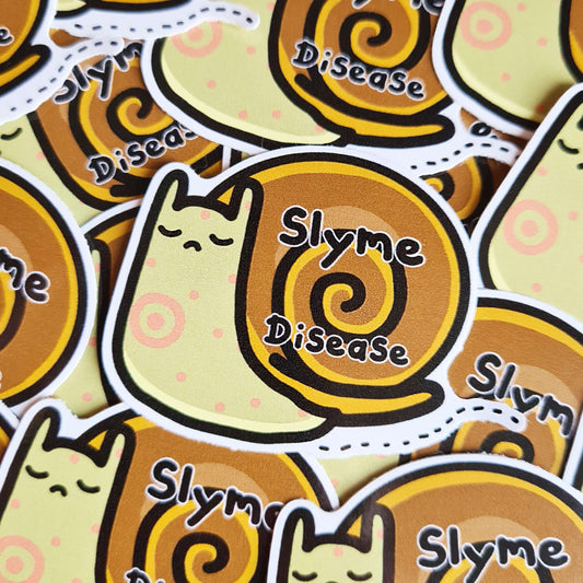 The Slyme Disease Sticker - Lyme Disease on a pile of multiple copies of the same sticker. The sad snail shape vinyl sticker is pastel green with red dots and target on its body, across its shell in black reads 'slyme disease'. The hand drawn design is raising awareness for lyme disease.