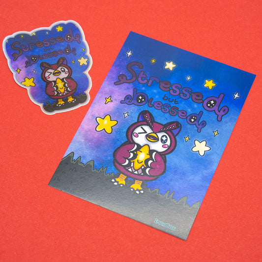 A flat lay showing the Innabox Stressed But Blessed Celeste Postcard alongside its matching vinyl sticker. The postcard features a cute owl character holding a glowing star fragment against a dreamy purple and blue night sky with yellow stars. Printed on 350gsm silk board, standard UK postcard size, and blank on the reverse. A comforting disability inspired design perfect for gifting or displaying.