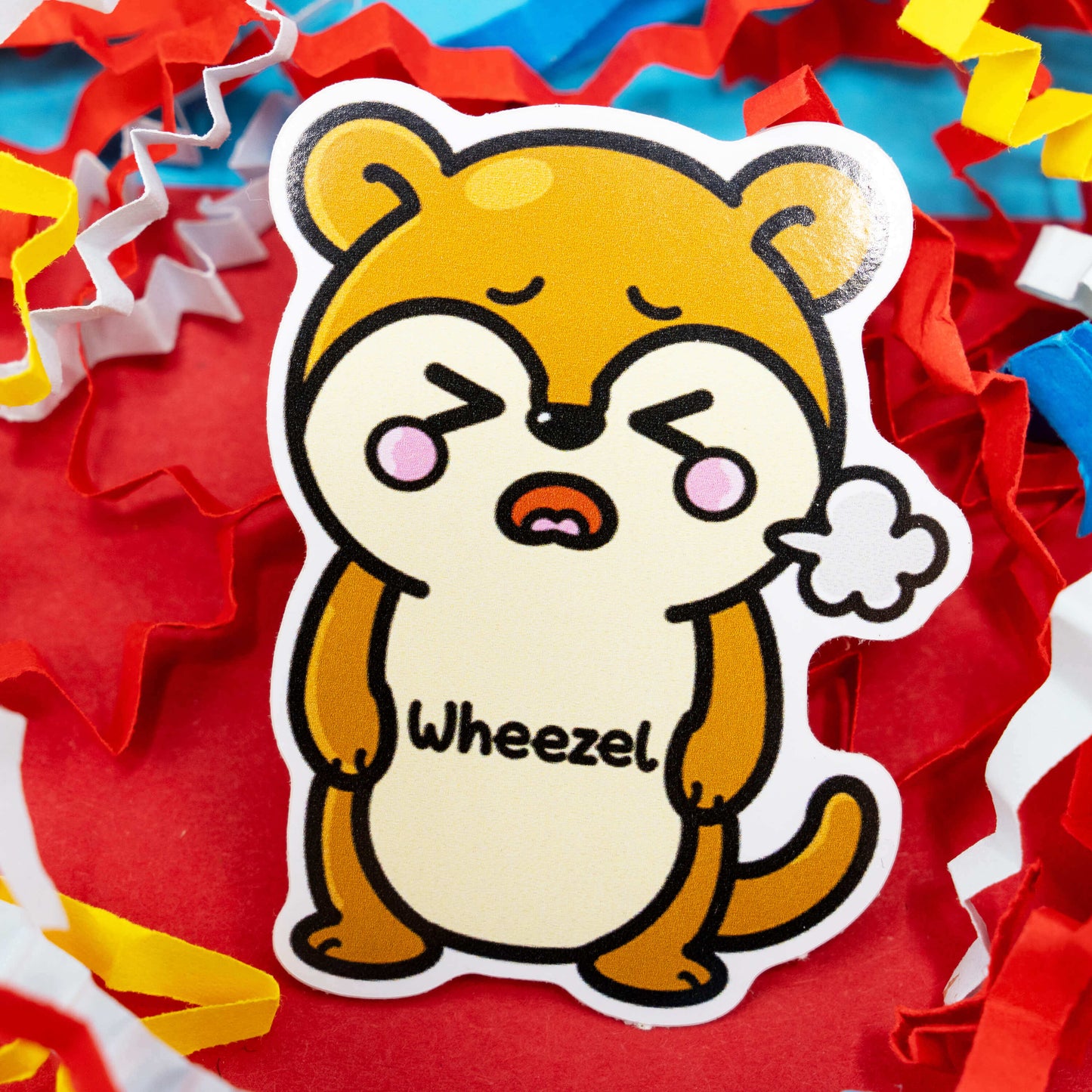 Adorable Wheezel the weasel vinyl sticker by Innabox, featuring a cute brown cartoon animal puffing out air to symbolise wheezing. A playful and supportive design inspired by asthma awareness and chronic illness. Gloss vinyl, waterproof, around 5 cm tall and custom cut. Created to bring comfort and a smile to anyone who needs it.