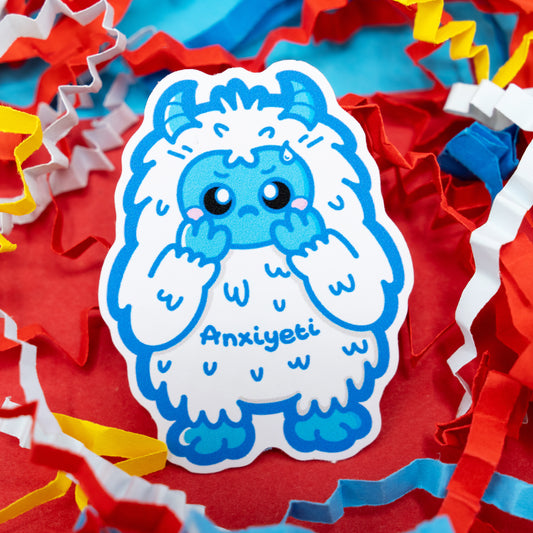 Anxi-Yeti vinyl sticker by Innabox showing a nervous blue yeti character on a red background with colourful confetti. Gloss vinyl anxiety awareness sticker that’s waterproof, durable, and perfect for decorating laptops, journals, or water bottles.