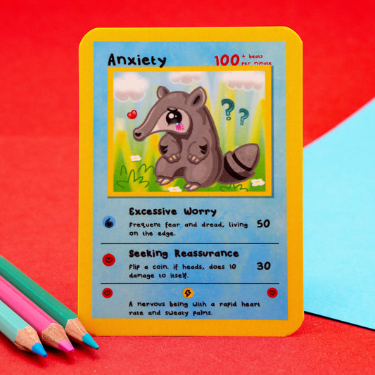 Close-up of the Anxiety card from the Innabox Neurodivergent Trading Card set. Features a nervous cartoon anteater holding its paws with hearts and question marks in the background. Text includes powers like “Excessive Worry” and “Seeking Reassurance.” Bright and uplifting design to raise awareness for hidden disabilities.
