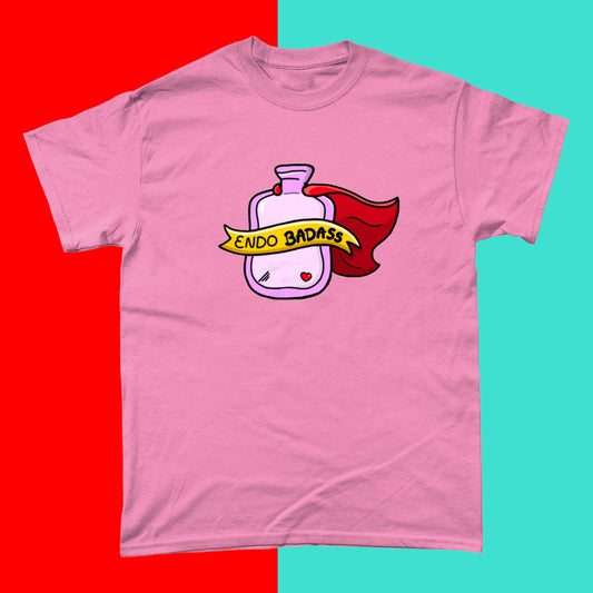 The Endo Badass Tee - Endometriosis on a red and blue background. The azelea pink tshirt has a pink hot waterbottle with a small red heart, red cape and yellow banner reading 'endo badass' in black text. The hand drawn design is raising awareness for endometriosis and pelvic pain.