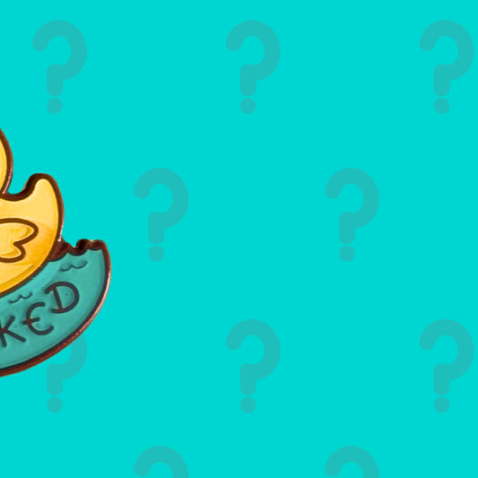 Close up teaser of the February Theme Exclusive Mystery Enamel Pin Subscription by Innabox. Cropped view of a colourful enamel pin character peeking in from the edge against a teal background with question marks, hinting at a playful disability inspired design.