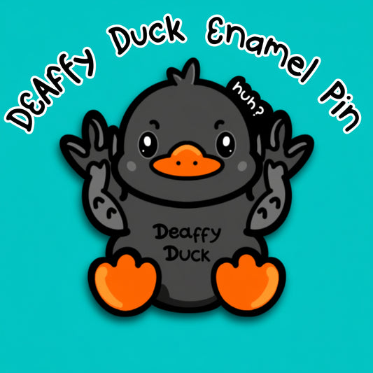 Deaffy Duck enamel pin by Innabox, featuring a cute black duck with orange beak and feet, holding their wings up in British Sign Language. Text reads Deaffy Duck Enamel Pin Pre Order on a teal background. Disability inspired pin celebrating deaf identity, BSL and hidden disabilities in a gentle, uplifting way.