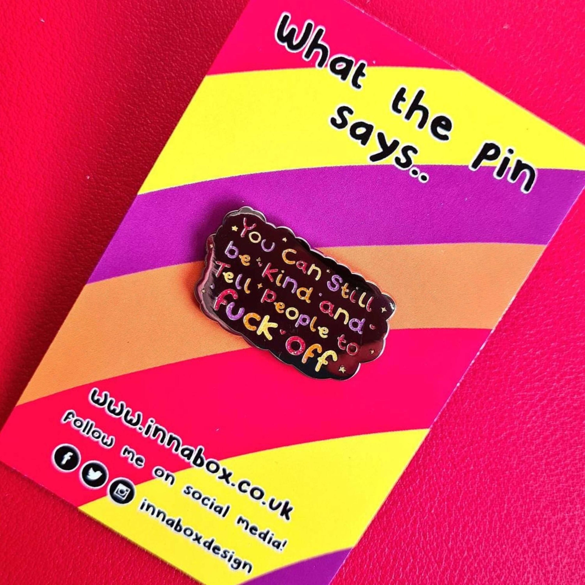 The You Can Still be Kind and Tell People to F**k Off Enamel Pin on rainbow backing card. The silver plated enamel pin has rainbow writing reading 'you can still be kind and tell people to fuck off' with multicoloured sparkles, dots and stars.