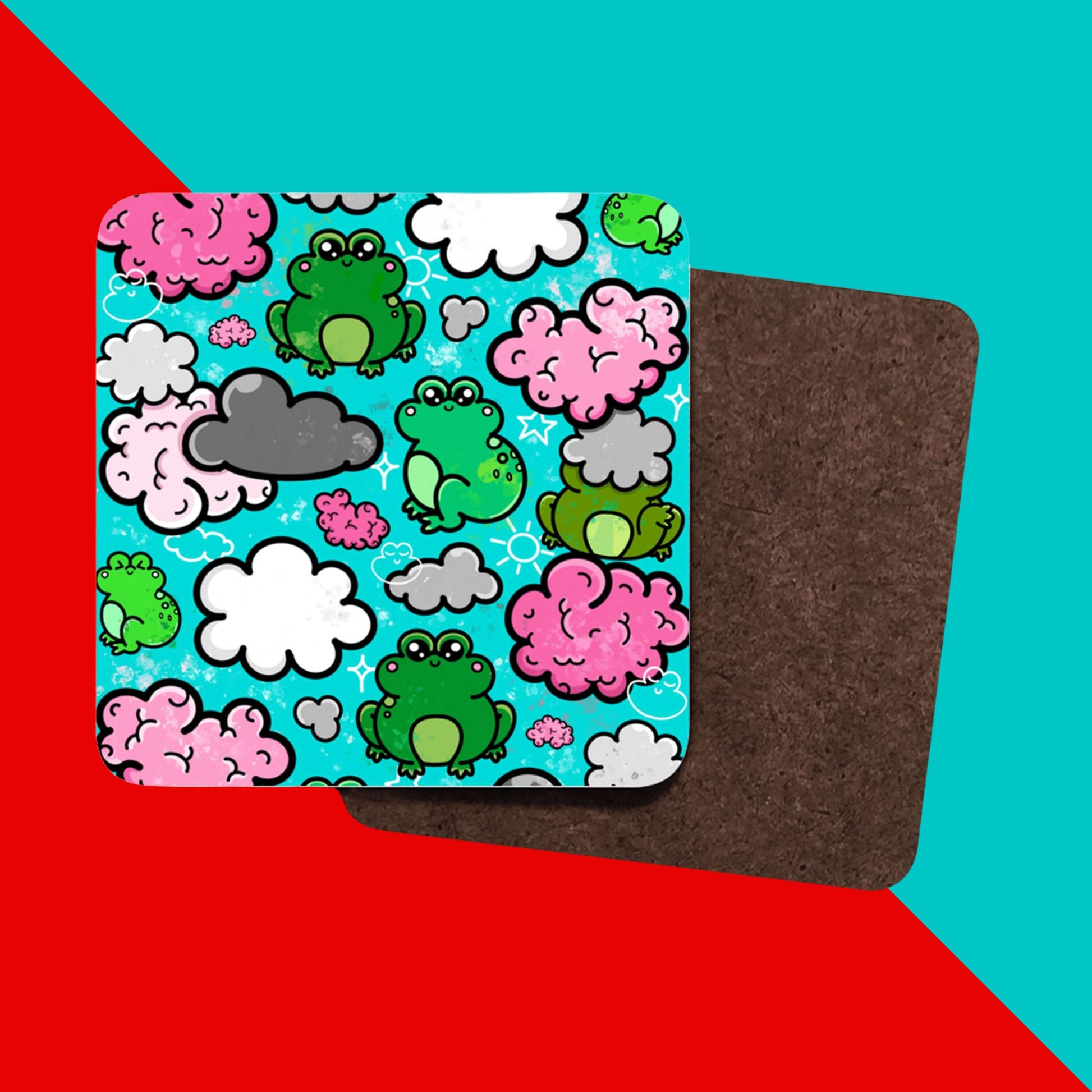 The Brain Frog Coaster - Brain Fog on a red and blue background. The wooden coaster features various happy kawaii face green frogs with pink brain style, grey and white clouds with white sparkles on a blue background. The design was created to raise awareness for brain fog.