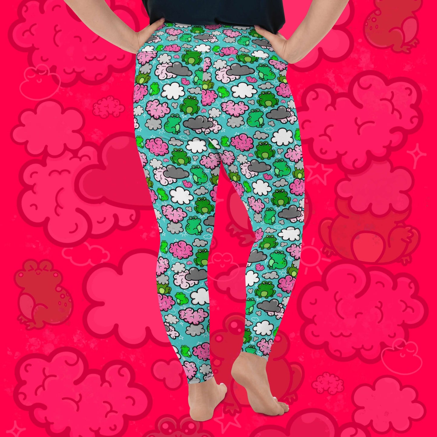 The Brain Frog Plus Size Leggings - Brain Fog being worn by a model facing away with their right leg bent on a red background with a faded brain frog print, the photo is cropped from the hips down. The leggings are an aqua blue base with various green kawaii face frogs with pink blush cheeks, pink brain style clouds, white and grey clouds and white sparkles all over. The design was created to raise awareness of Brain Fog.