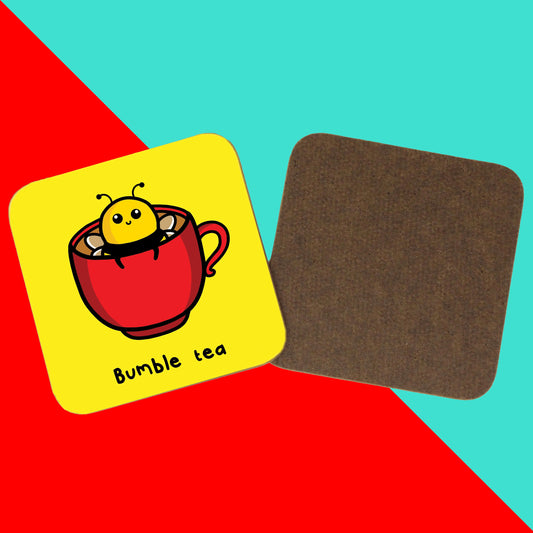 The Bumble Bee Tea Coaster on a red and blue background. The yellow wooden coaster features a cute bumble bee popping out a red cup of tea with black text underneath reading 'bumble tea', on the right is the wooden underside of the coaster. 