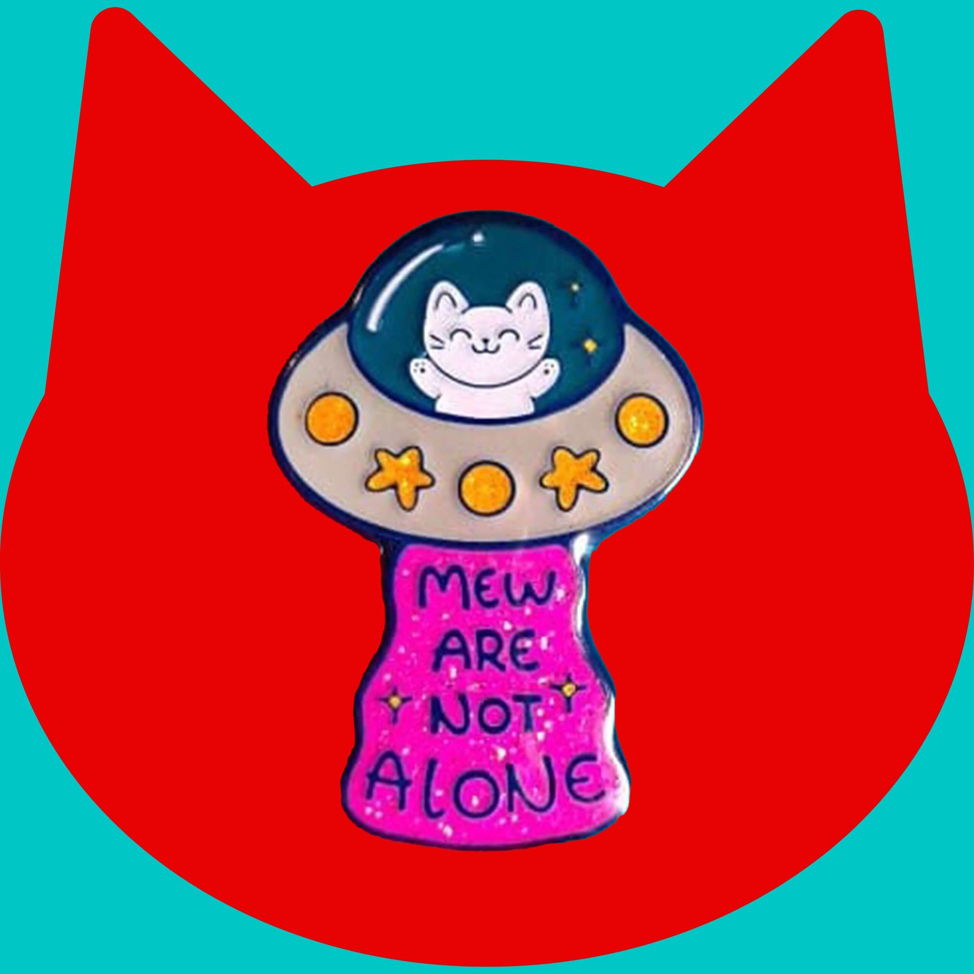The Cat UFO Mew are not Alone Enamel Pin on a red and blue background. The blue outline pin is of a white smiling cat in a silver ufo spaceship with yellow glittery stars and circles, underneath is pink glittery beam with blue text reading 'mew are not alone' a pun on you are not alone.