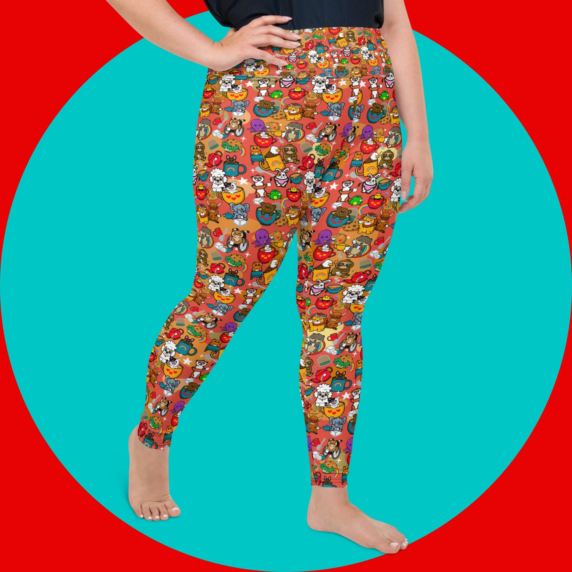 The Disabili Tea and Biscuits - Disability Plus Size Leggings being modelled by a femme person wearing a black tee on a red and blue background. The leggings feature various disabled and chronically ill animal characters drinking tea, sitting in tea mugs and holding up mugs. There is also various cookie biscuits, tea bags, sugar cubes, teapots, rainbows, sparkles and tea spills all underneath. The leggings are a punny gift raising awareness for disabilities.