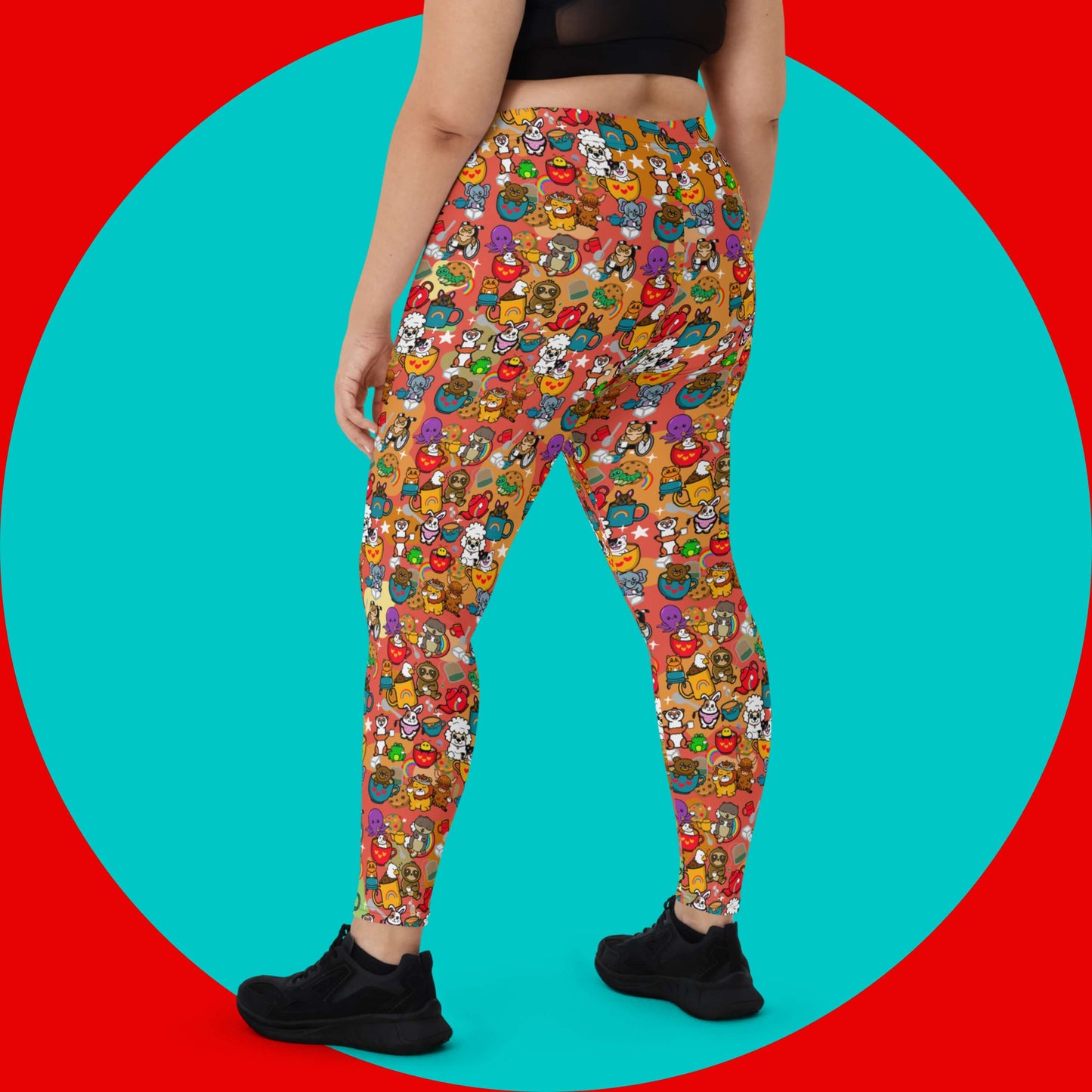 The Disabili Tea and Biscuits - Disability Leggings being modelled by a femme person wearing a black tee and black trainers on a red and blue background. The leggings feature various disabled and chronically ill animal characters drinking tea, sitting in tea mugs and holding up mugs. There is also various cookie biscuits, tea bags, sugar cubes, teapots, rainbows, sparkles and tea spills all underneath. The leggings are a punny gift raising awareness for disabilities.