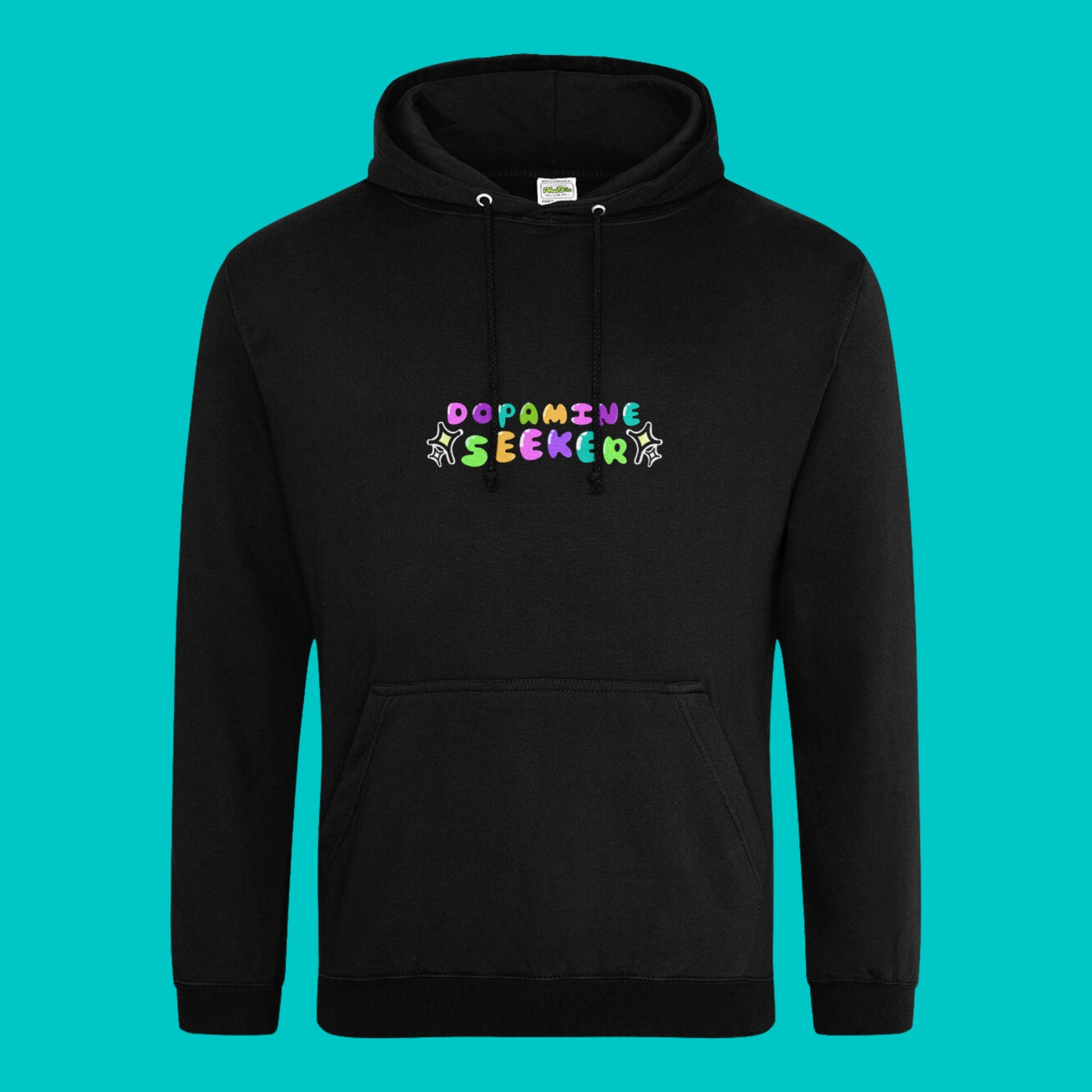 The Dopamine Seeker Black Hoodie on a blue background. The black cotton hoodie features centre rainbow bubble text that reads 'dopamine seeker' with yellow and black sparkles surrounding it. The hoodie has black drawstrings and a large centre pocket. The hoodie was designed to raise awareness for ADHD and neurodivergence.