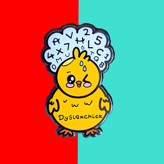 The Dyslexchick Enamel Pin - Dyslexia on a red and blue background. A yellow confused chick shaped pin badge with a thought bubble above its head full of letters and numbers with 'dyslexchick' written across its middle. The hand drawn design is raising awareness for dyslexia.