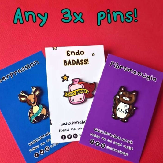 Three Innabox enamel pins shown on backing card on a red background. Choose from any three pins. Enamel pins designed to raise awareness for chronic illnesses