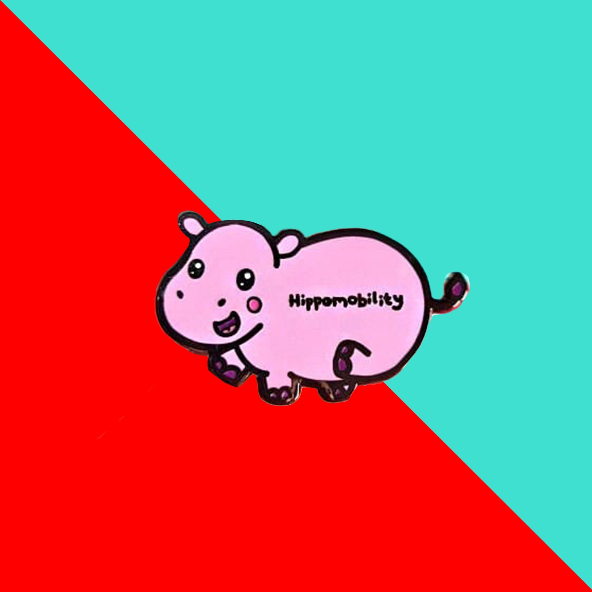 Hippmobility Enamel Pin - Hyper Mobility shown on a red and blue background. The enamel pin is of a pink happy hippo with the text hippomobility written on its stomach. The enamel pin is designed to raise awareness for hyper mobility