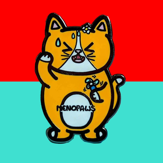 Menopaws Enamel Pin - Menopause shown on a red and blue background. The enamel pin is of a menopausal ginger and white cat with a daisy in it's hair. The cat is holding an electric fan and is looking hot with sweat droplets on it's face. Hand drawn design made to raise awareness for menopause