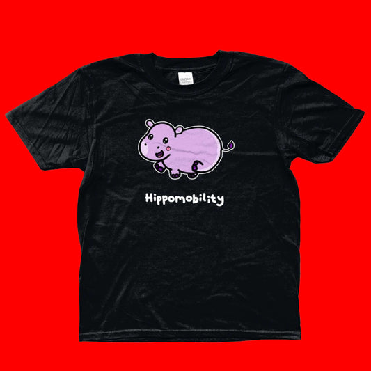 Hippomobility Tee - Hyper Mobility Tee shown on a red background. The black t-shirt has an illustration of a pink happy hippo with 'hippomobility' in white text underneath. The hand drawn design is made to raise awareness for hyper mobility.