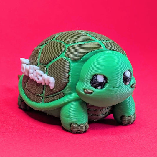Three quarter view of a green 3D printed tortoise fidget toy with expressive black and white eyes. Tortism Tortoise Desk Buddy by Innabox, a small autism friendly sensory fidget and desk companion, photographed on a bright pink background.
