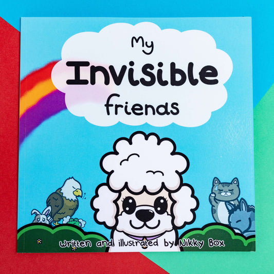 The My Invisible Friends Children's Book on a red, blue and green background. The blue book features a white smiling poodle with disabled innabox characters in the background with a rainbow and white cloud above with black text reading 'my invisible friends' and bottom black text reading 'written and illustrated by Nikky box'. Raising awareness for invisible illnesses.