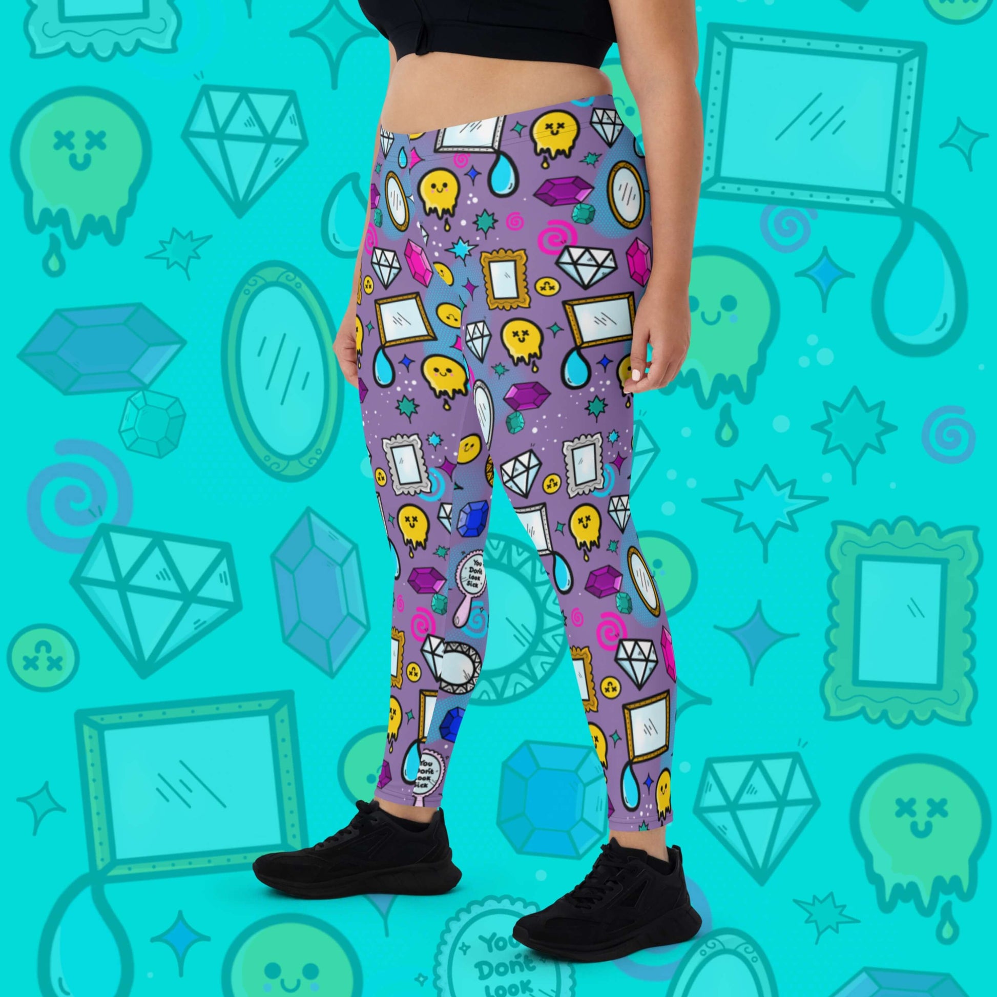 The You Don't Look Sick Leggings modelled by a femme person facing left with a black tshirt and black trainers on a blue background with a faded version of the print. The purple base leggings features melting yellow smiley faces, mirrors, gemstones, teardrops, sparkles, swirls and dots with a centre hand held mirror reading 'you don't look sick'. The hand drawn design is raising awareness for invisible illnesses.