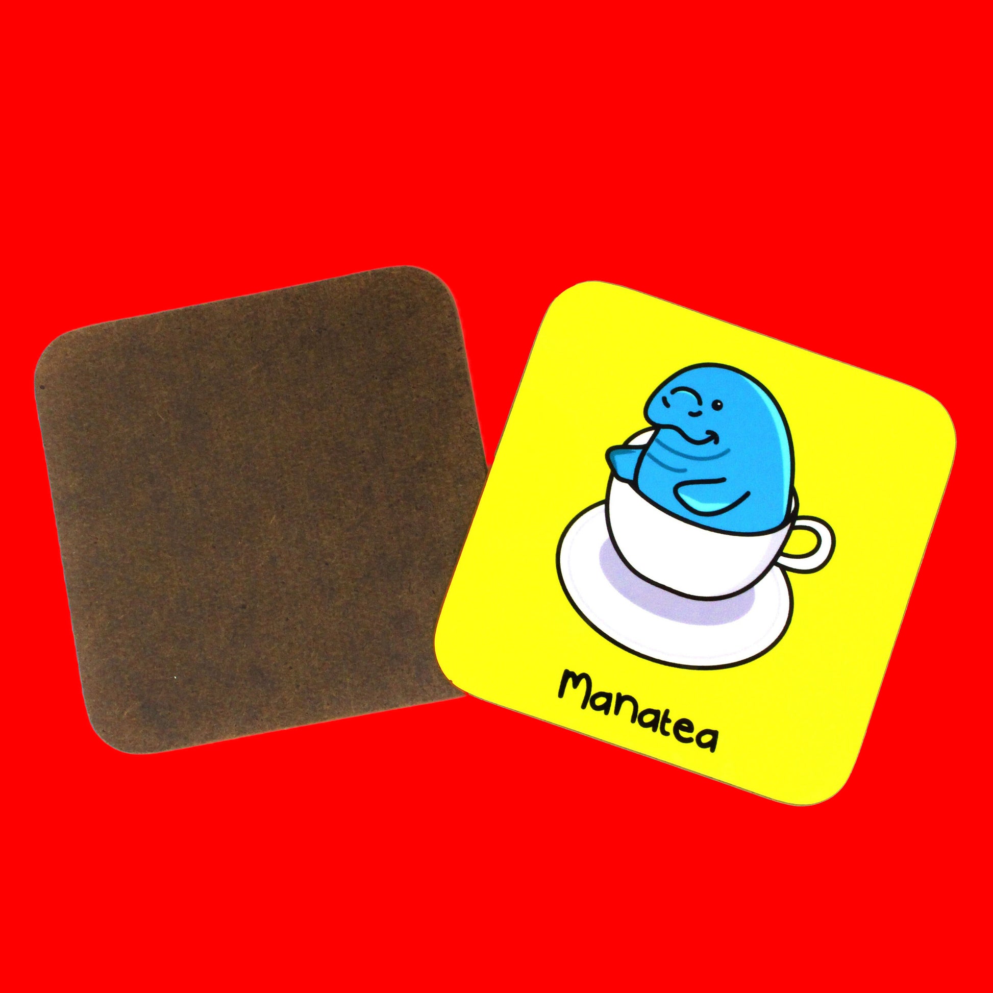 Mana Tea Manatee Coaster on a red background. The bright yellow wooden coaster has an illustration of a smiling manatee sat in a white tea cup on top of a saucer.