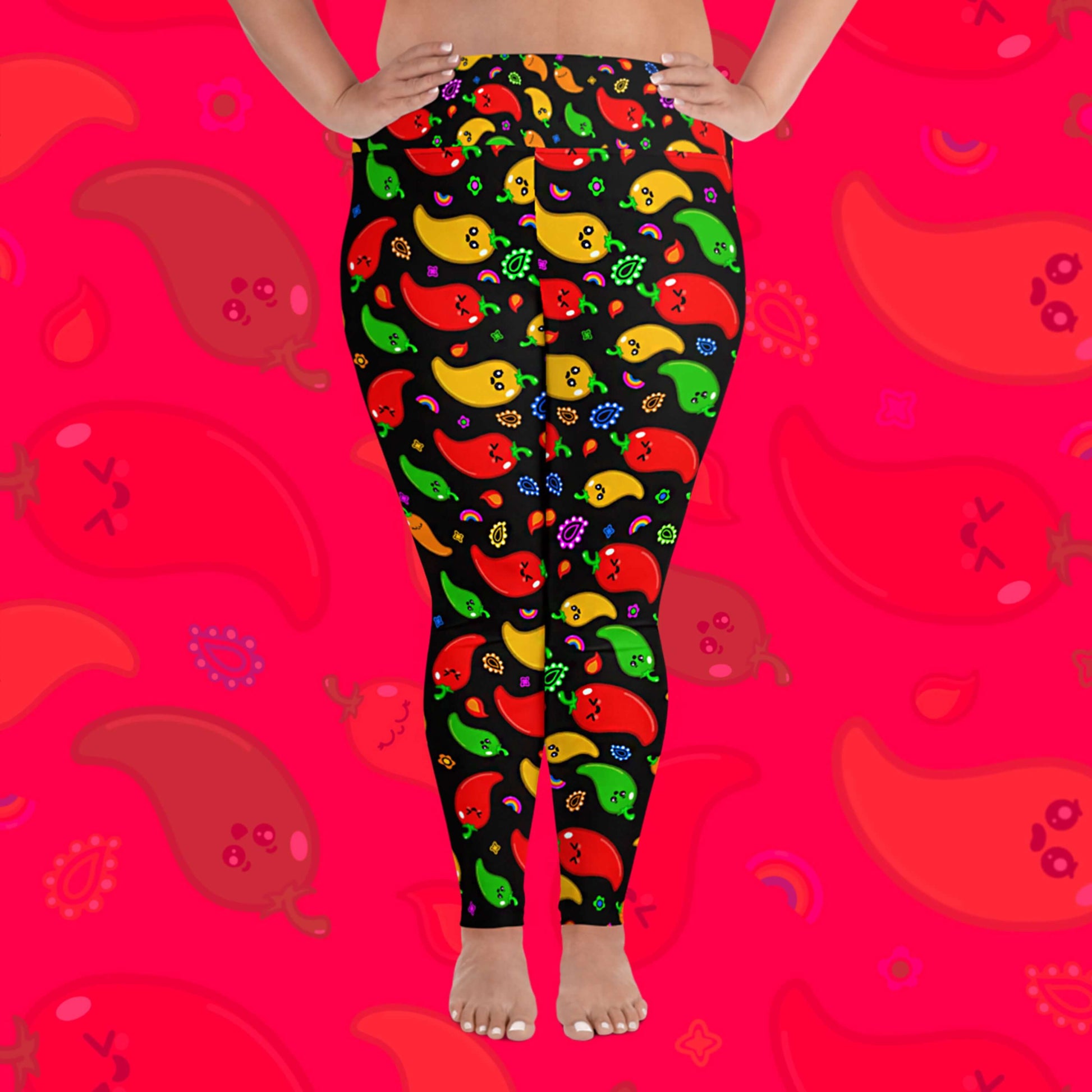 Black leggings with red, green, orange and yellow chilli peppers with cute faces on and various cute doodles around them shown on a model's legs. The background of the photo is a faded close up of the print. The hand drawn design is raising awareness for neurodiversity.