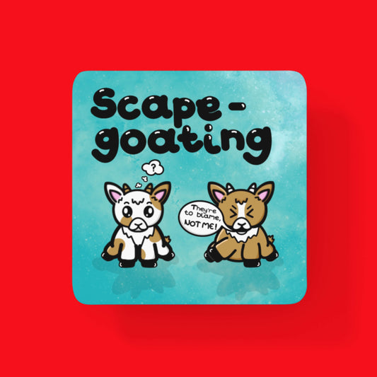 The Scape Goating Coaster - Scapegoat on a red background. The blue wooden coaster features two white and brown baby goats, the one on the right has its eyes closed pointing a hoof to the other goat with a speech bubble reading 'they're to blame, not me!'. The goat on the left looks confused and has a thought bubble with a ? inside. Above both goats in black text reads 'scape-goating'.