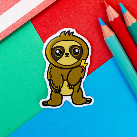 Scoliosis sticker shown on a red and blue background. The sticker is a cute sloth with wide eyes, a little smile and fluffy head. The sloth is standing on it's legs with feet turned outwards. The sloth has one arm hanging lower than the other and has one red shoulder with a yellow lightening bolt above it. 'Slowliosis' is written down the other arm in black writing.