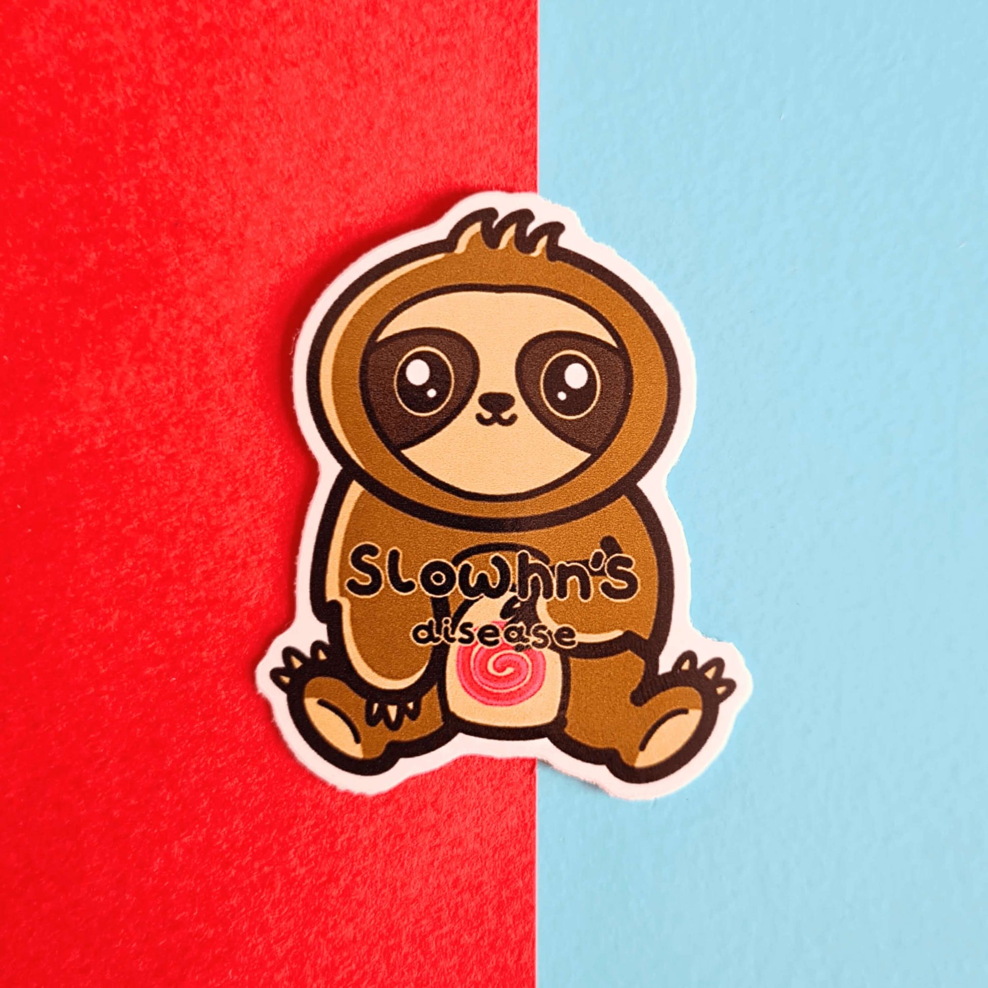 The Slowhn's Disease Sloth Sticker - Crohn's Disease on a blue and red background. The sloth shape sticker is smiling sat down clutching its tummy that has a red swirl and text reading 'slowhn's disease'. The design is raising awareness for crohn's disease.