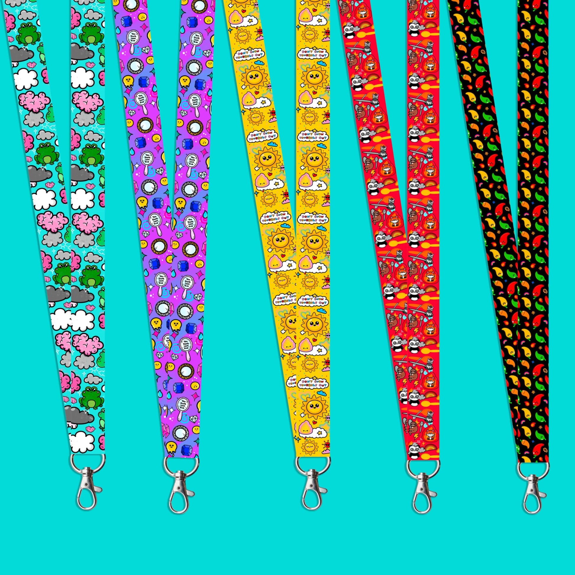 An image depicting all four lanyard with various prints by Innabox on an aqua backdrop