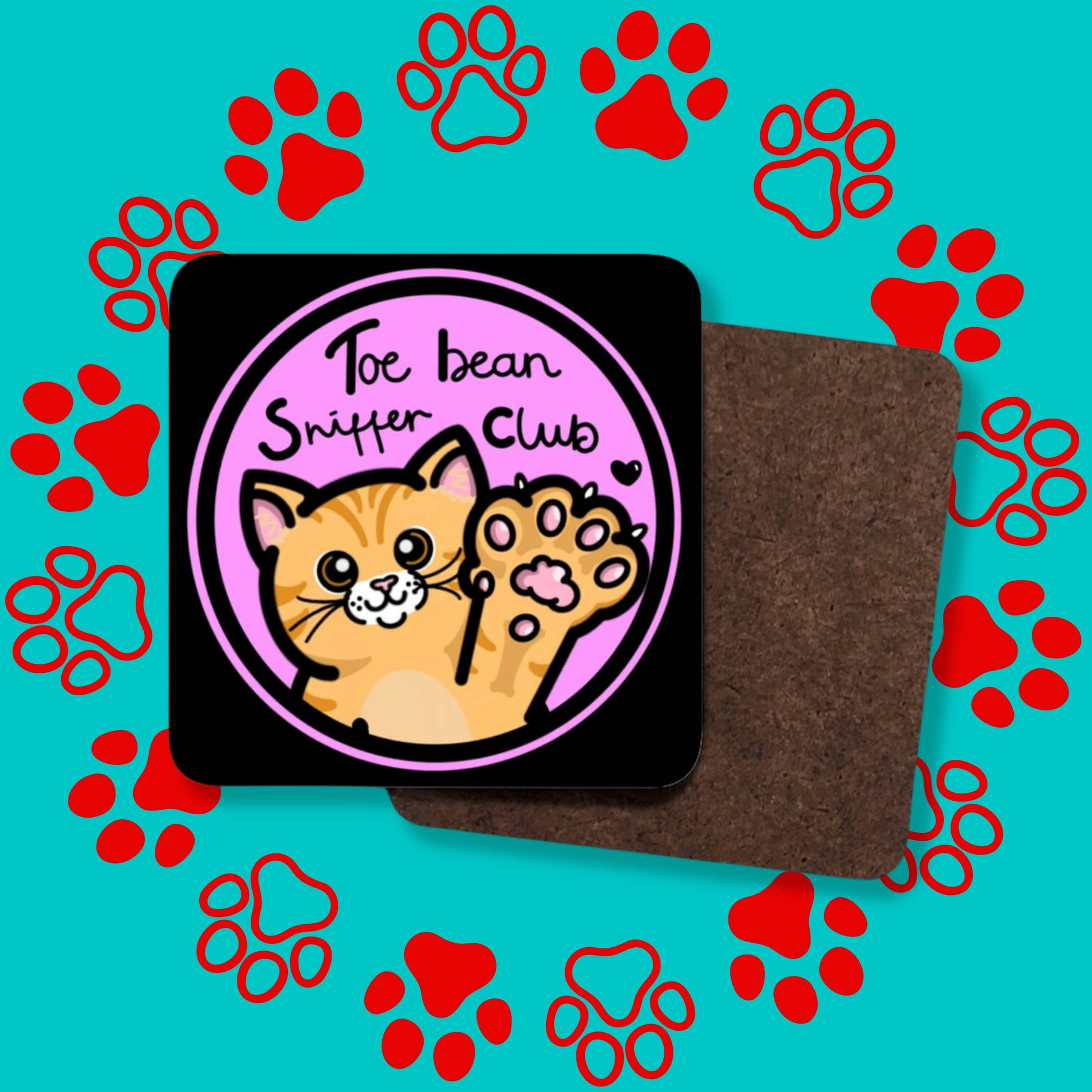 Collage of the Toe Bean Sniffer Club Coaster facing forward and backwards to show the plain wooden back on a red and blue paw print background. The black wooden coaster with rounded edges has a pastel pink circle with black text reading 'toe bean sniffer club' with an orange smiling cat lifting its paw up with a black heart.