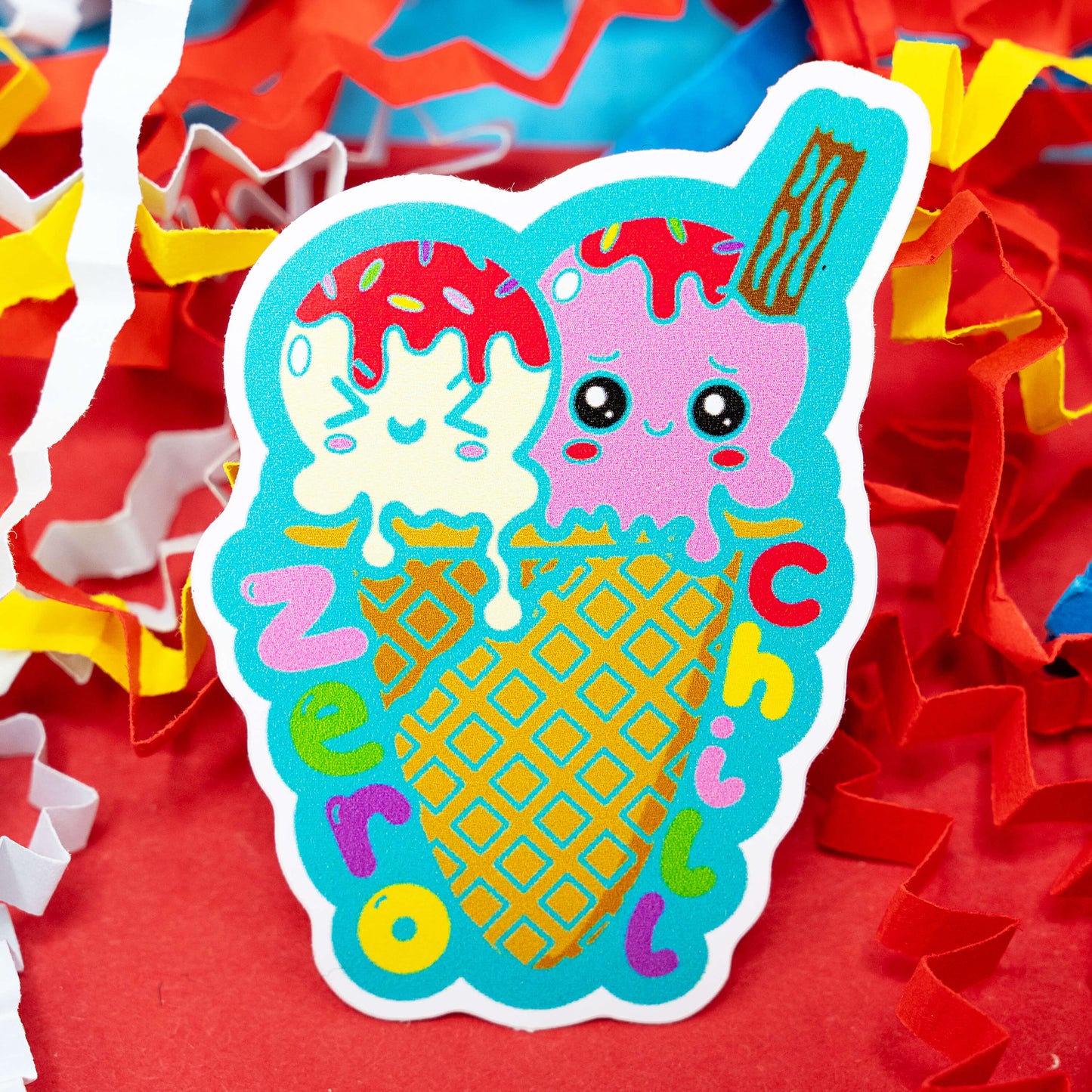 A colourful gloss vinyl sticker by Innabox featuring two cute cartoon ice cream scoops with pink and cream faces melting together in a waffle cone with the words “Zero Chill” in bright rainbow letters. Surrounded by cheerful red, yellow, and white confetti, this 5 cm waterproof sticker celebrates neurodivergent humour and positivity for those with chronic illness or hidden disabilities.