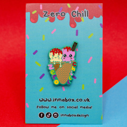 Zero Chill Ice-cream Cone Enamel Pin by Innabox, displayed on a colourful blue sprinkle-themed backing card with red drippy details. The pin features two scoops of ice cream with kawaii-style faces and a flake, in a waffle cone with the words “Zero Chill” in rainbow letters. A cute, awareness-raising pin designed to uplift those with hidden disabilities.