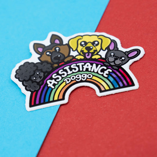 Assistance Doggo awareness sticker by Innabox featuring four cute cartoon service dogs above a rainbow with bold text.