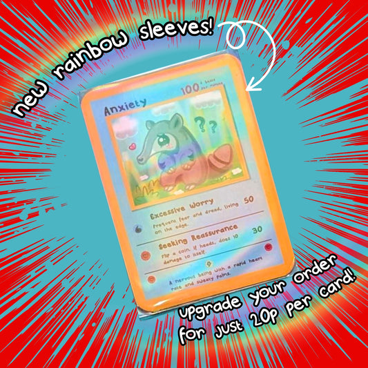 An Anxiety trading card from Innabox featuring a grey anteater character is displayed inside a rainbow holographic sleeve against a red and blue comic-style background. Text reads: “New rainbow sleeves! Upgrade your order for just 20p per card!”