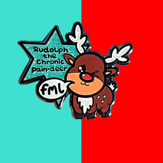 Rudolph The Chronic Pain-Deer Christmas Pin in front of a blue background. The enamel pin has a cute brown reindeer with white antlers, white spots and white fluffy belly and tail. The reindeer has a bright red nose and one eye closed. There is a white speech bubble coming from the reindeer's mouth with 'fml' written inside in black letters. The pin also has a glittery blue star coming from behind the reindeer with 'Rudolph the chronic pain-deer' written in black letters inside it.