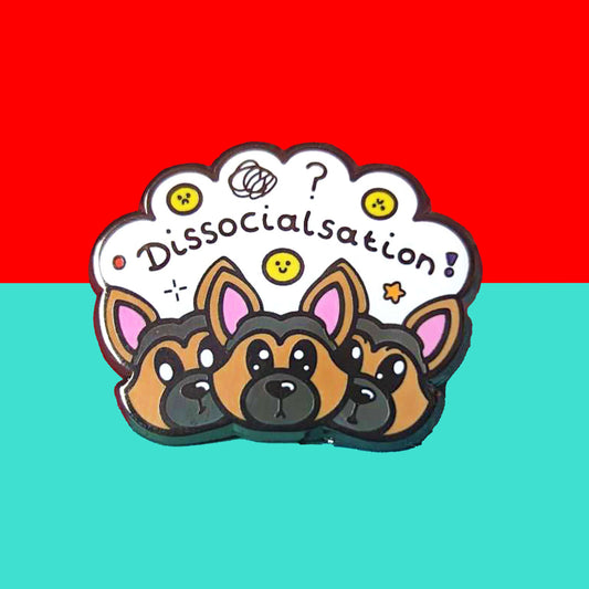 The Dissocialsation Enamel Pin - Dissociation on a red and blue background. Three confused brown and black Alsatian dog heads with their ears perked up, above them is a white cloud with sad and happy yellow faces, sparkles, question marks and black text reading 'dissocialsation!'. The design is raising awareness for dissociation.