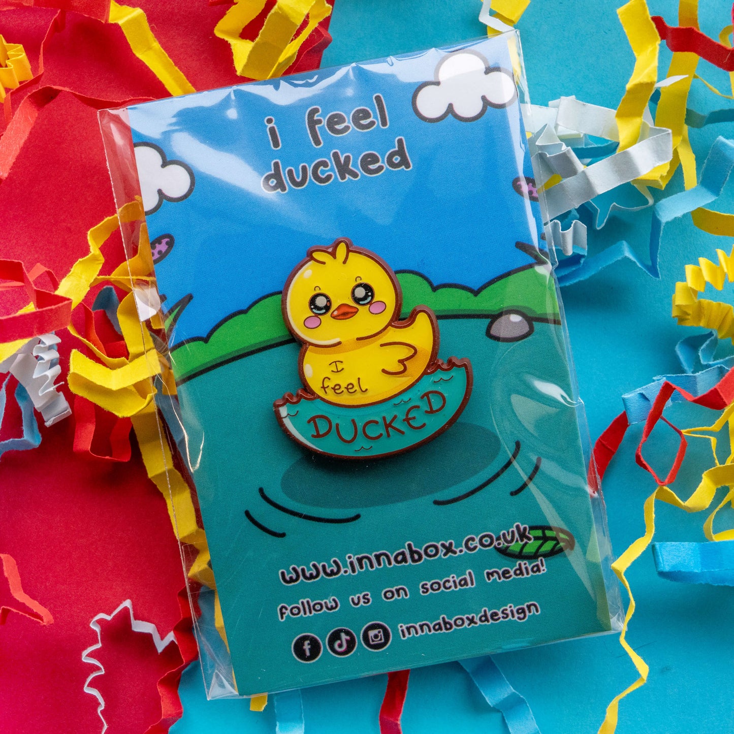 Innabox I Feel Ducked enamel pin packaged in a clear protective sleeve on illustrated backing card. Cute yellow duck hard enamel pin with rubber clutch backs, designed to raise awareness for chronic illness and hidden disabilities.