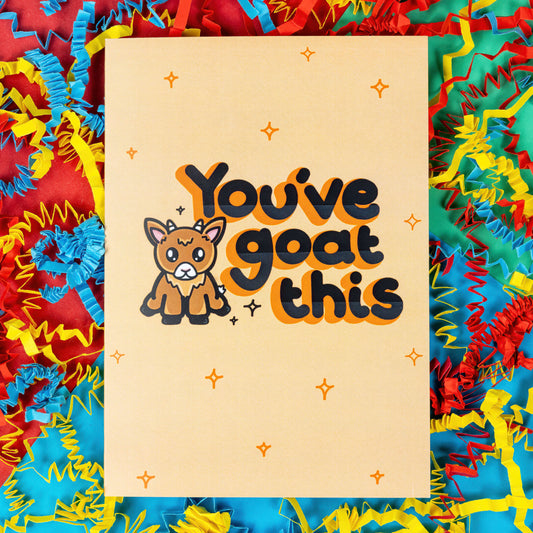 You've Goat This Card on a red, blue and green background with card confetti decorations. The pale yellow card with orange sparkles drawn on it has black text with an orange shadow that reads 'you've goat this'. There is an illustration of a cute brown goat. The hand drawn design is made to raise awareness for chronic and invisible illnesses.