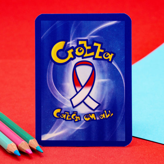 The back of the Neurodivergent Trading Card by Innabox, styled like a retro game card with a red, white and blue ribbon in the centre and the phrase “Gotta Catch ’em all.” Designed for those with chronic illness and neurodivergence.
