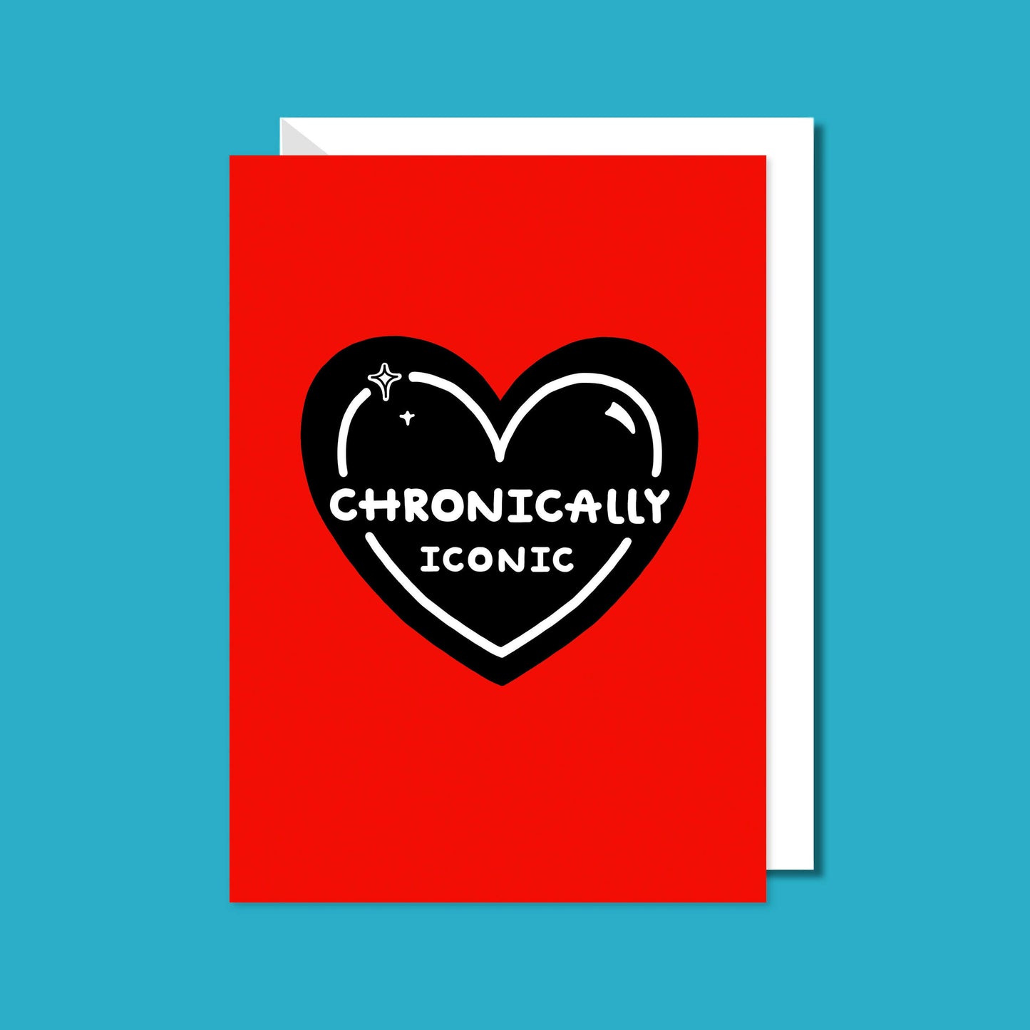The Chronically Iconic Card on a blue background with a white envelope underneath. The red a6 greeting card features a black heart with a white outline, sparkles and text that reads 'chronically iconic'. The design is to raise awareness for chronic illness.