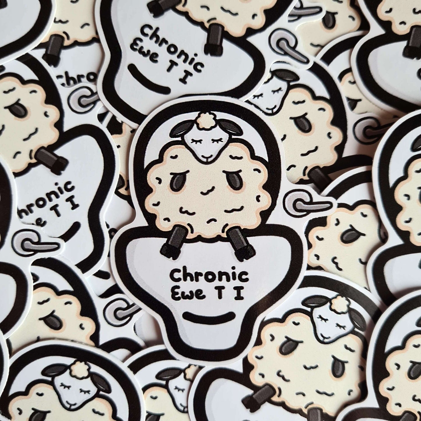 Chronic Ewe T I Sticker - Chronic UTI on a pile of multiple stickers. The sticker features a white sad sheep sat on a large white toilet with black text reading chronic ewe T I. The design is raising awareness for chronic utis.