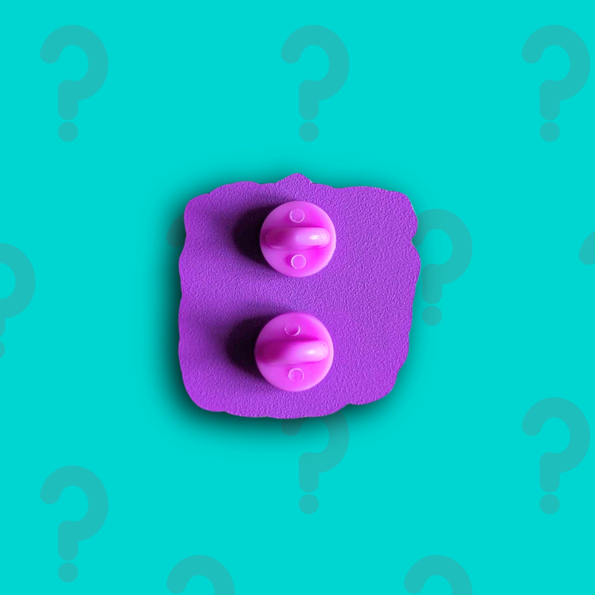 Back view of Innabox March Mystery Enamel Pin showing two pink rubber clutch backs on a purple enamel base. Exclusive enamel pin subscription created by Innabox to uplift people living with chronic illness and hidden disabilities.
