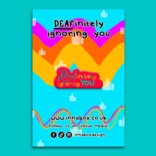 Bright promotional graphic for the Innabox Deafinitely Ignoring You enamel pin. Colourful wavy rainbow shapes sit on a turquoise background with thumbs up icons. Playful text reads Deafinitely Ignoring You. The design celebrates Deaf identity and British Sign Language with a bold, uplifting and inclusive feel. Disability inspired design by Innabox for people with chronic illness or hidden disabilities.