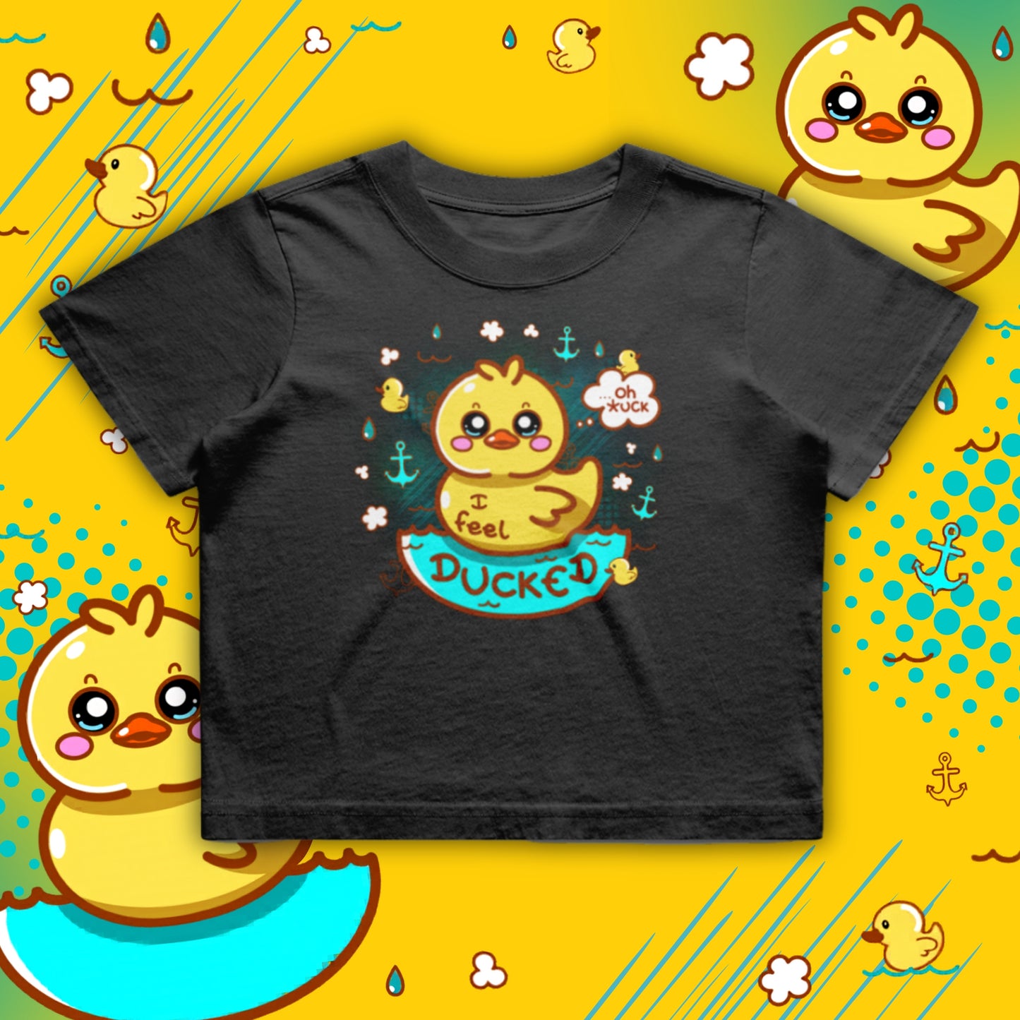 Black cropped T-shirt featuring a cute yellow duck illustration with the phrase “I Feel Ducked”. The duck sits in blue water surrounded by small ducks, raindrops and anchors. Playful, colourful graphic on a boxy, oversized crop tee by Innabox, a disability positive brand supporting chronic illness and hidden disabilities.
